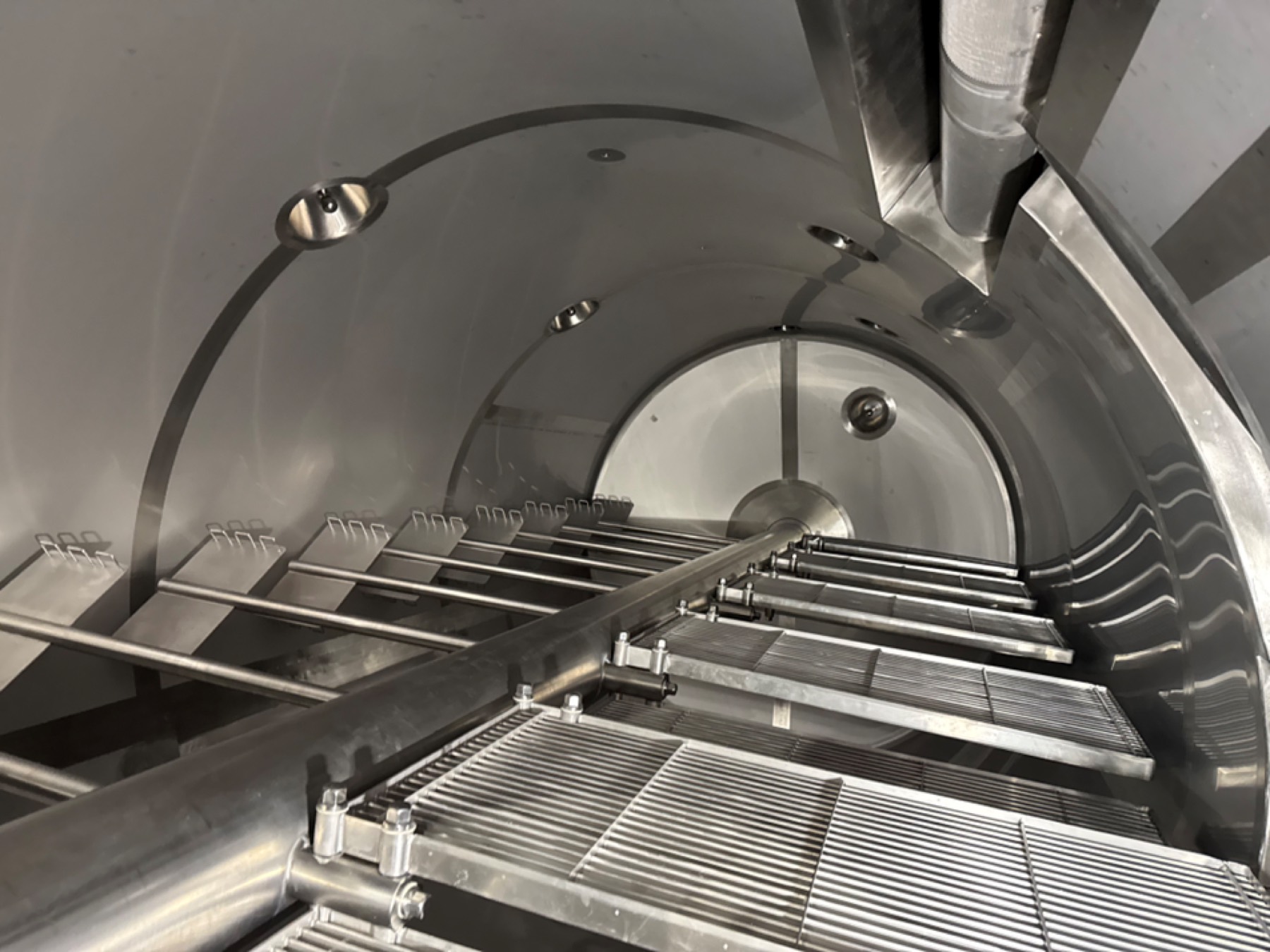 Cutting and stirring tools inside a cheese vat from HSV Combi.